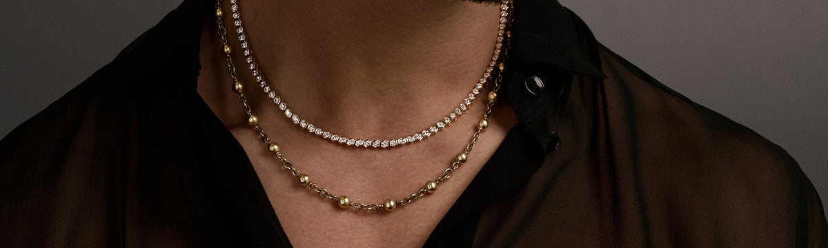 Model wearing diamond and gold chain necklace