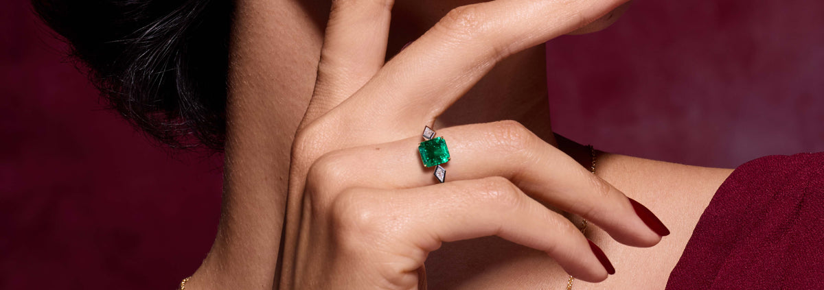 emerald and diamond three stone ring