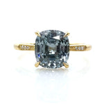 18K YELLOW GOLD HANDCRAFTED "LAUREL CATHEDRAL" 4-PRONG ENGAGEMENT RING WITH 0.01TCW ROUND BRILLIANT DIAMOND ACCENTS AND MILGRAIN DETAIL FEATURING A 1.96CT LIGHT BLUE CUSHION CUT MONTANA SAPPHIRE BY ERIKA WINTERS.