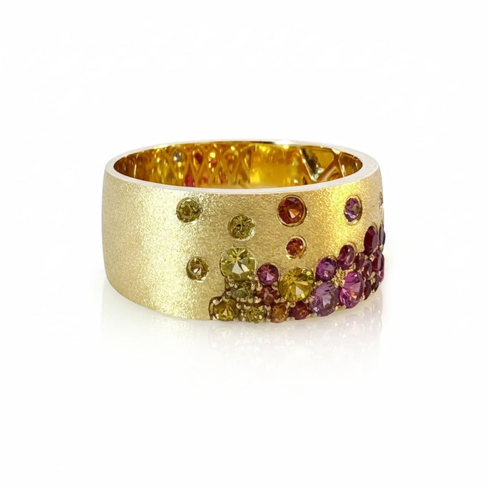 14K YELLOW GOLD CIGAR BAND WITH SATIN FINISH FEATURING 1.36TCW RAINBOW SAPPHIRES & TSAVORITES FLUSH SET, FROM STARDUST BY G.ST.

SIZE 6.75